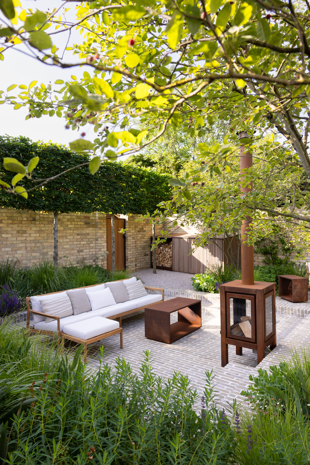 Colm Joseph Cambridge courtyard garden design sunken seating area clay pavers pleached trees