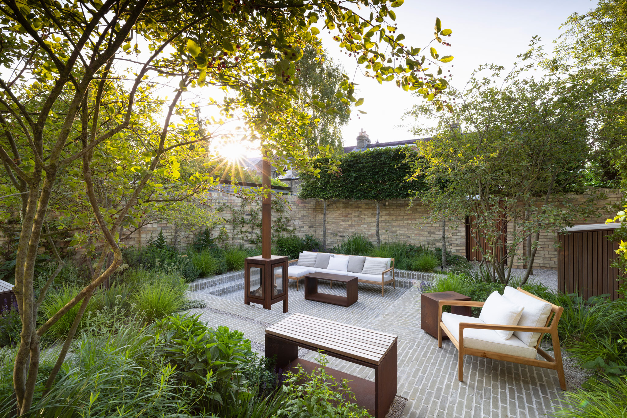 Colm Joseph Cambridge courtyard garden design sunken seating area clay pavers pleached trees