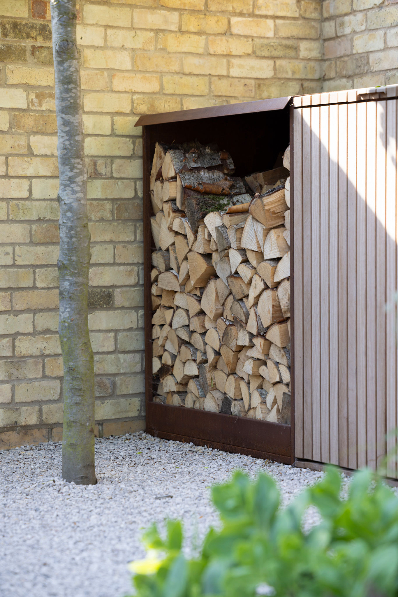 Colm Joseph Cambridge courtyard garden design wood store pleached tree in gravel
