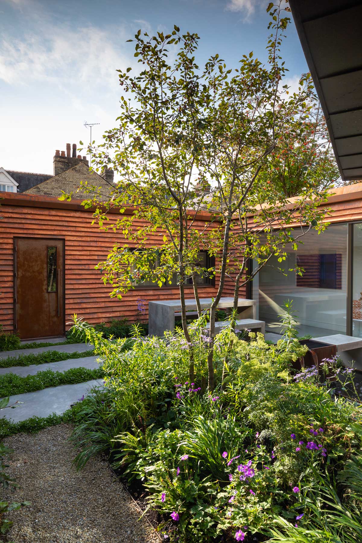 Colm Joseph garden design Cambridge courtyard modern house concrete paving corten steel water feature concrete table and benches