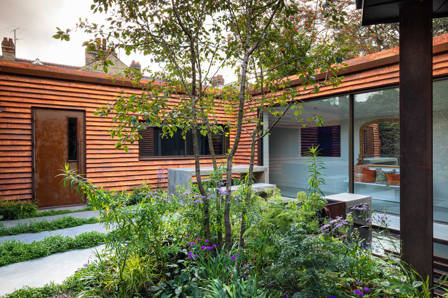 Colm Joseph Cambridge garden designer modern architecture naturalistic planting grasses multi-stem tree pleached beech trees concrete furniture