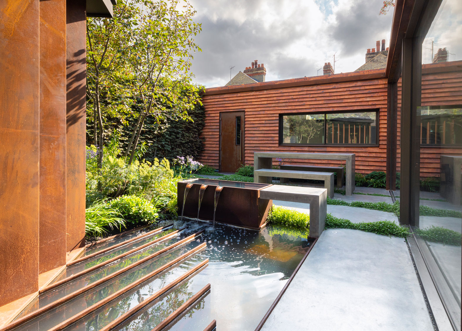 Colm Joseph Cambridge garden designer modern architecture naturalistic planting grasses multi-stem tree pleached beech trees concrete furniture