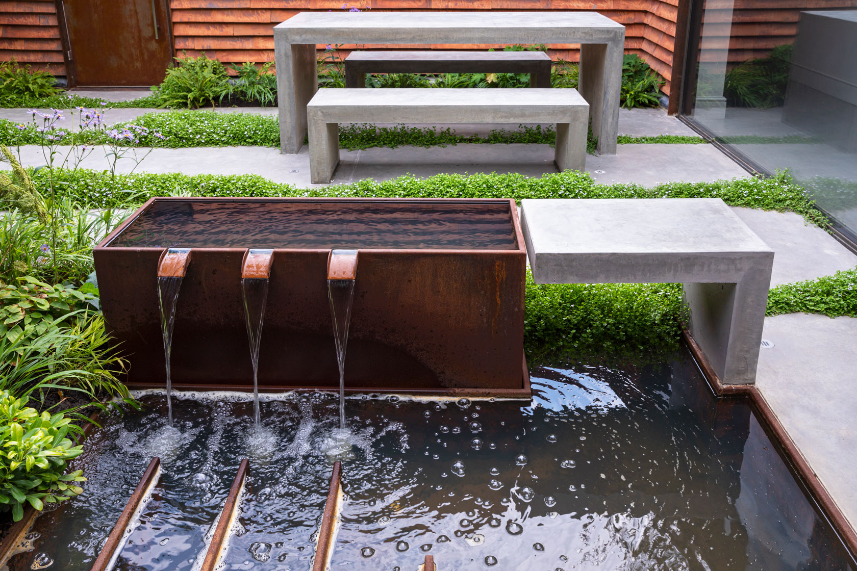 Colm Joseph Cambridge garden design modern courtyard corten steel water feature concrete paving and concrete furniture